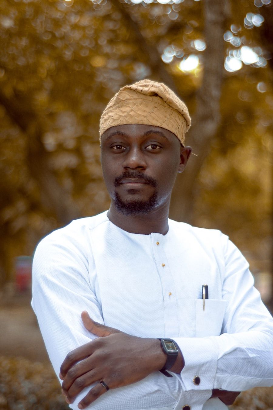 Portrait of a man in a white kaftan and cap, outdoors